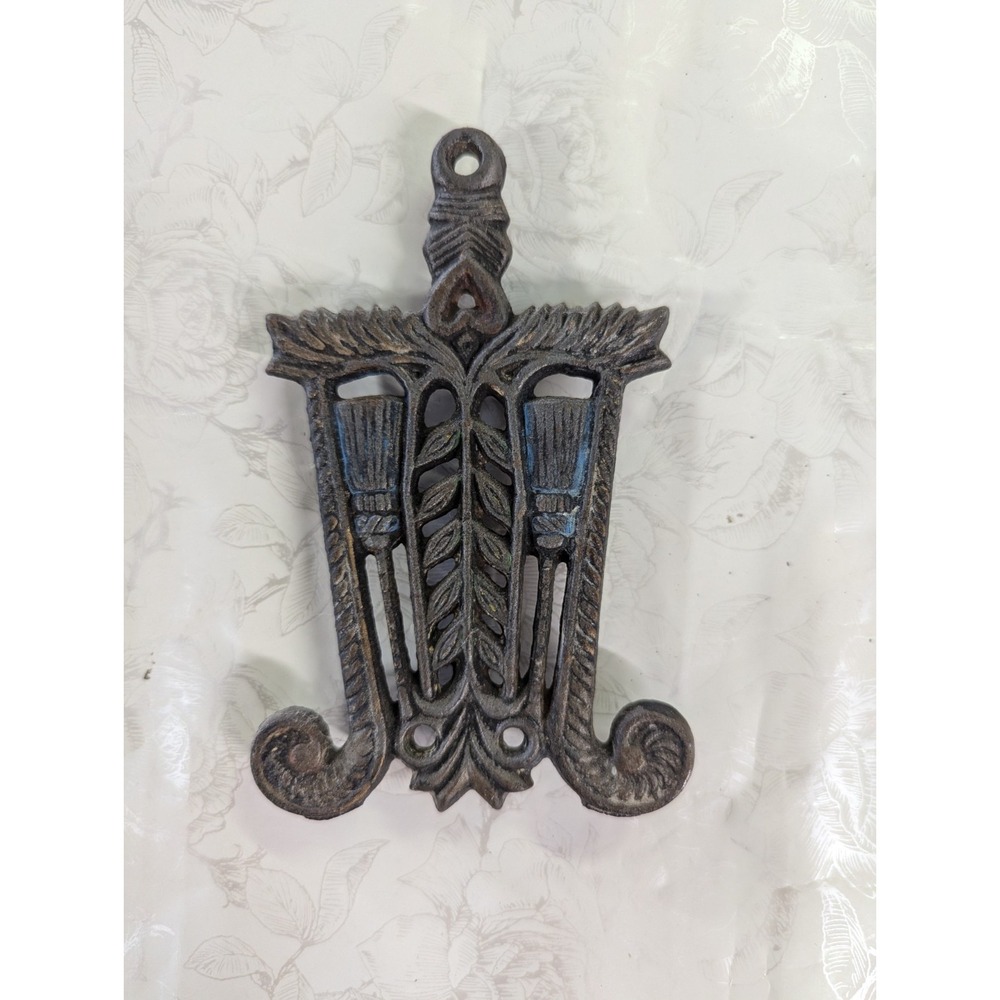 Small Wilton Trivet Cast has broom design